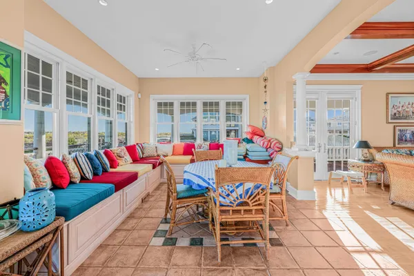 a living room with a baby crib furniture and a kitchen view
