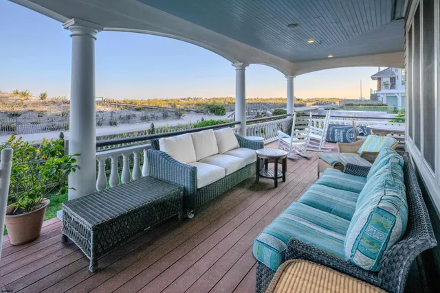 a outdoor living room with furniture and a floor to ceiling window
