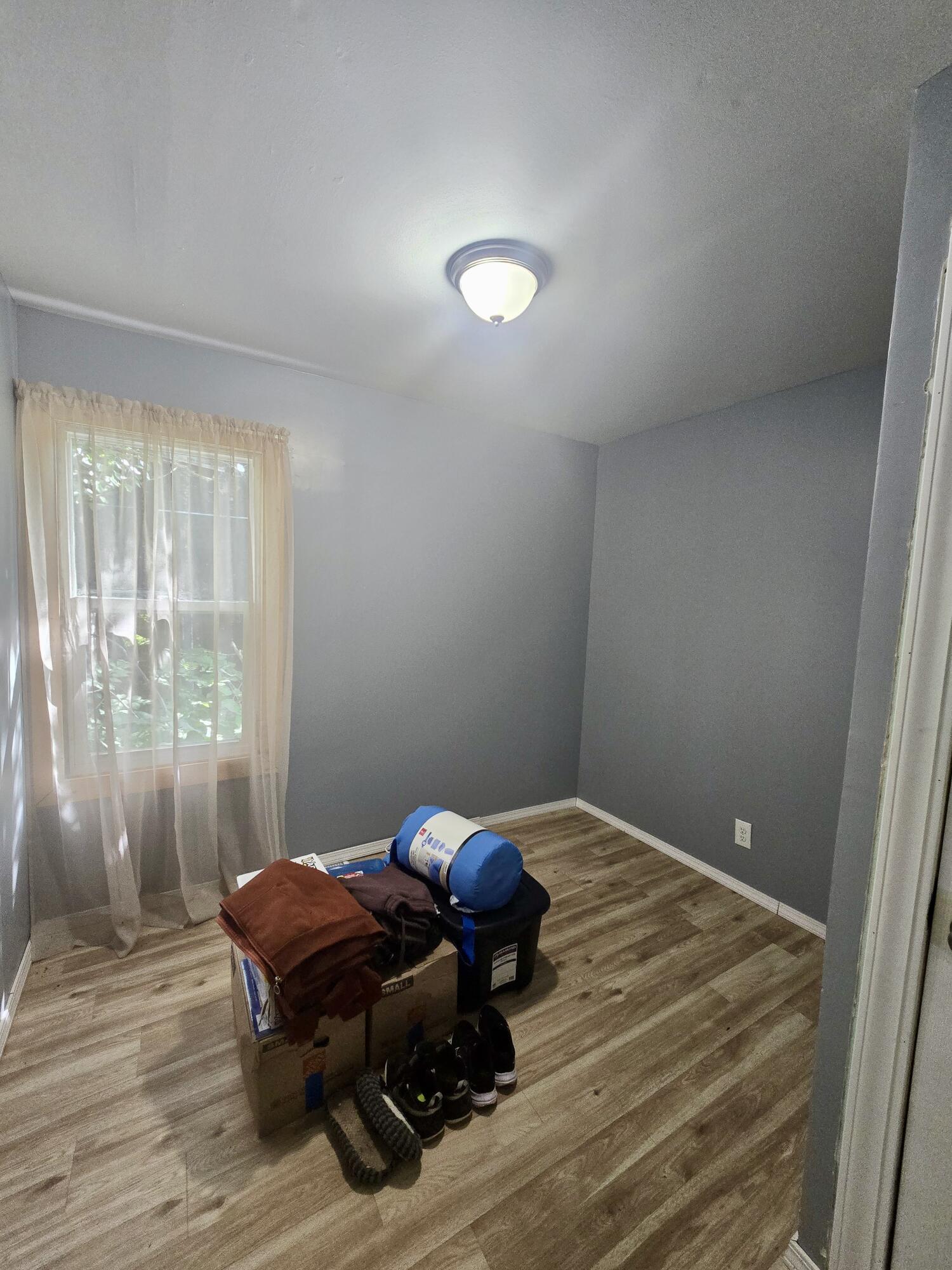4613 Maryland Street Gary, IN 46409 - Photo 13 of 24 a bedroom with a bed and wooden floor