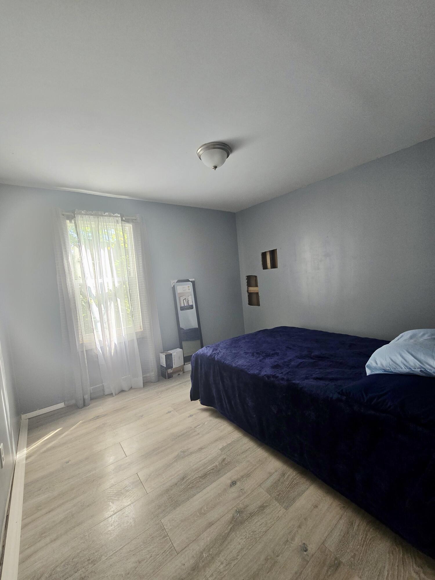 4613 Maryland Street Gary, IN 46409 - Photo 16 of 24 a bedroom with a bed and a window