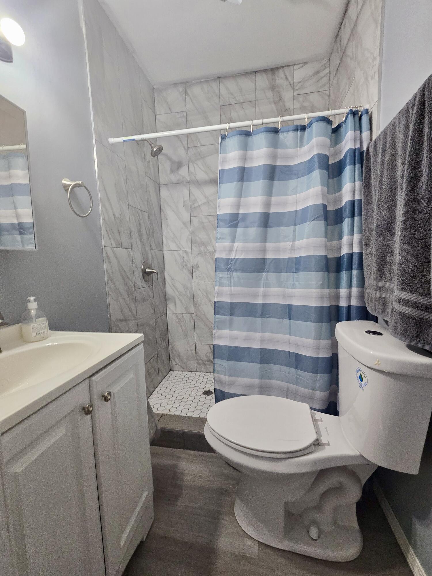 4613 Maryland Street Gary, IN 46409 - Photo 18 of 24 a bathroom with a toilet and a shower curtain