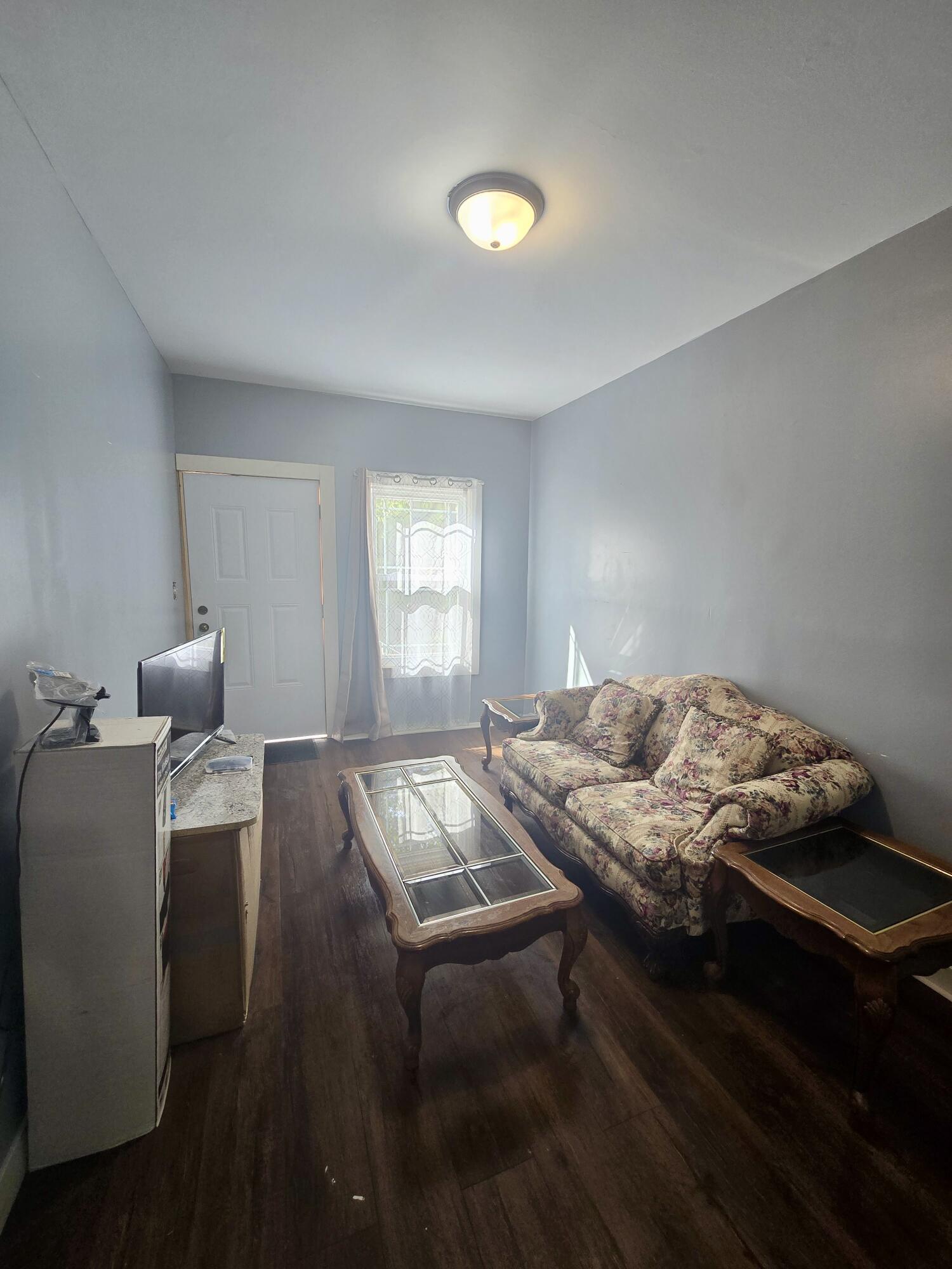 4613 Maryland Street Gary, IN 46409 - Photo 4 of 24 a bedroom with a bed and window