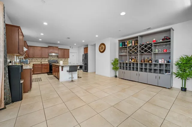 a kitchen with a sink a counter top space appliances and cabinets