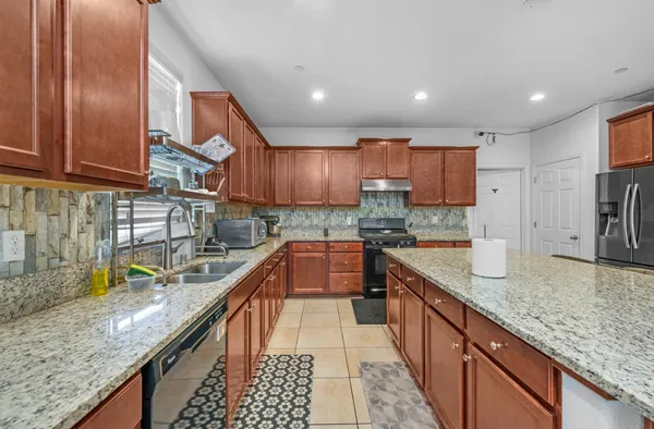 a living room with furniture a store and lots of white walls