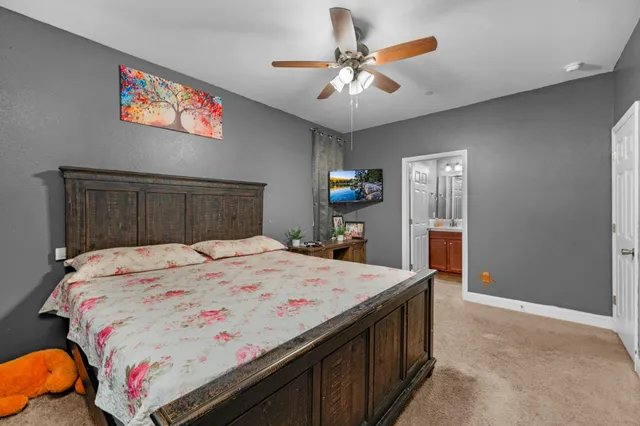 a bedroom with a large bed and a chandelier