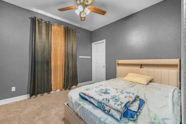 a bed sitting in a bedroom next to a window