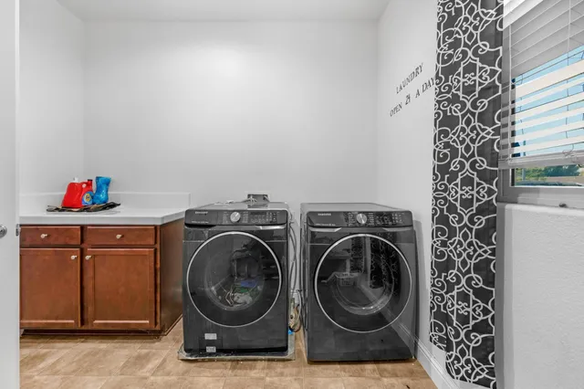 a view of pool with outdoor seating and house in the background