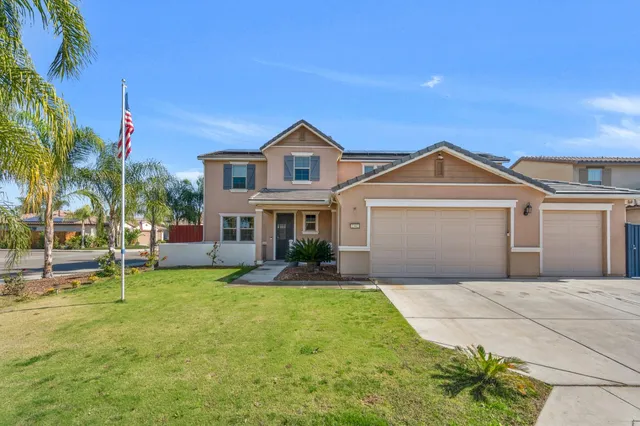 a front view of a house with a yard and garage