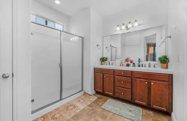 a view of a patio with table and chairs with wooden fence