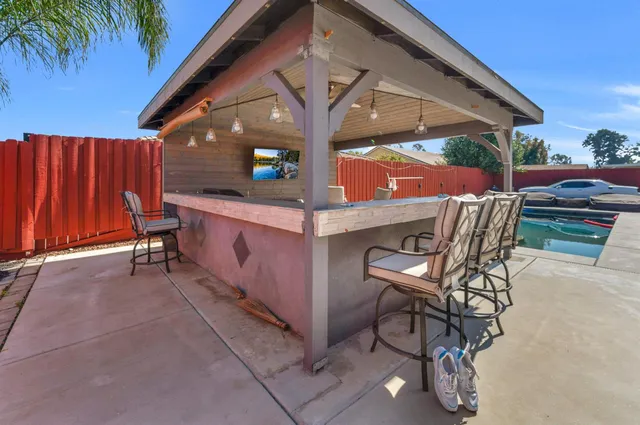 an aerial view of a house with a garden and deck