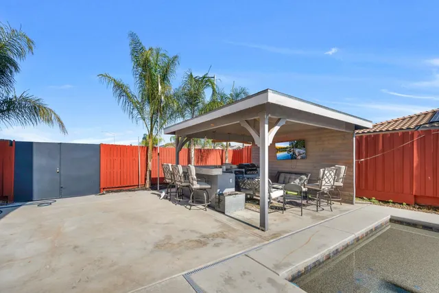 a front view of a house with outdoor seating