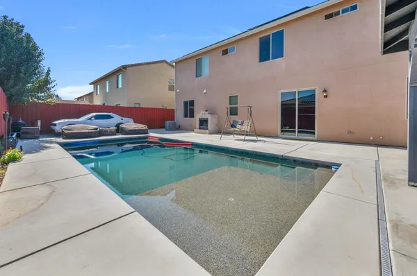 an aerial view of a city with lots of residential buildings and mountain view in back