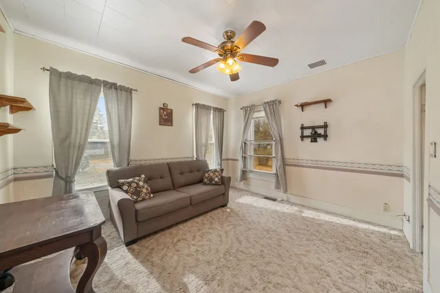 a living room with furniture and kitchen view