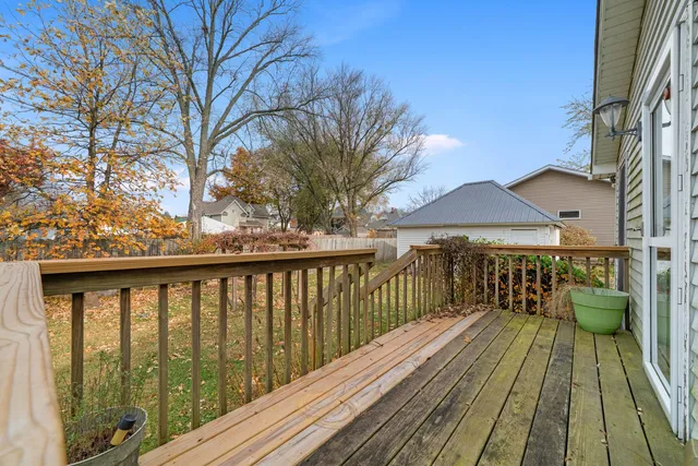 a view of balcony with wooden floor and fence