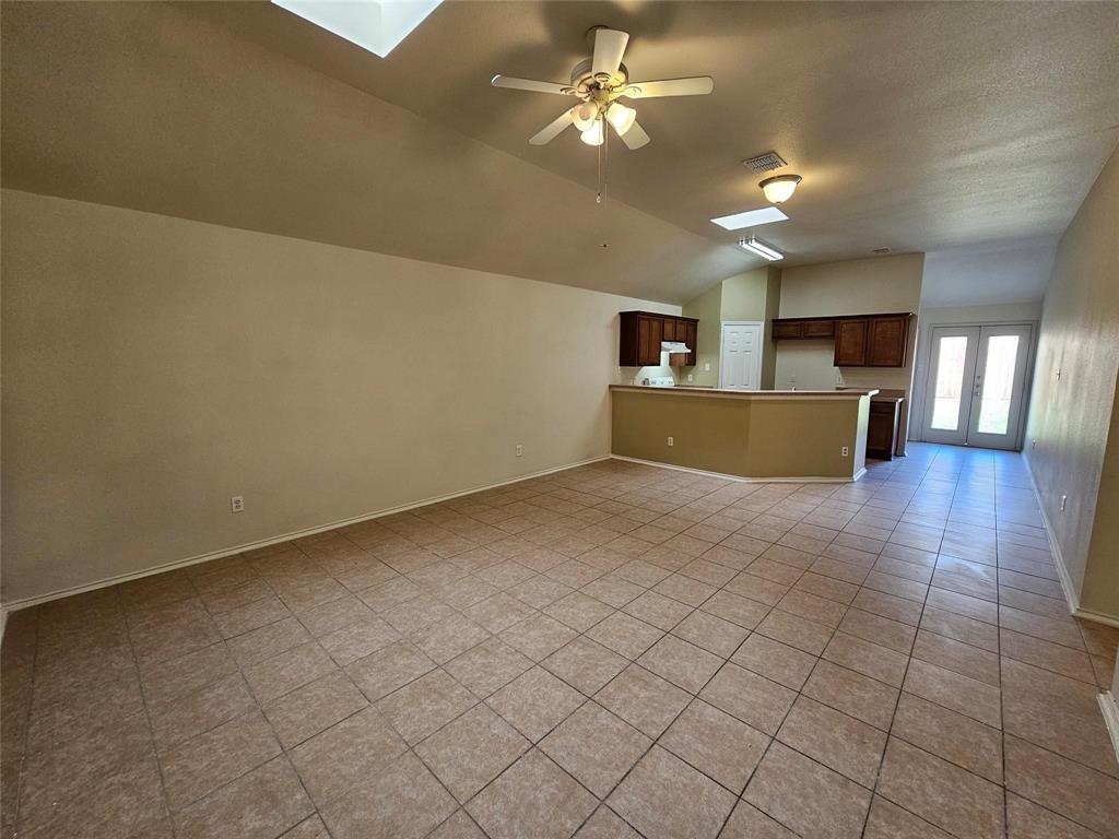17406 Energy Lane Dallas, TX 75252 - Photo 7 of 15 a view of a kitchen with furniture and a ceiling fan