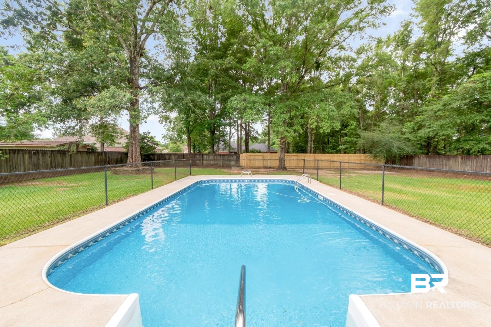10691 Hunters Ridge Drive Mobile, AL 36695 - Photo 3 of 37 Outdoor swimming pool featuring a curved end and surrounding concrete decking