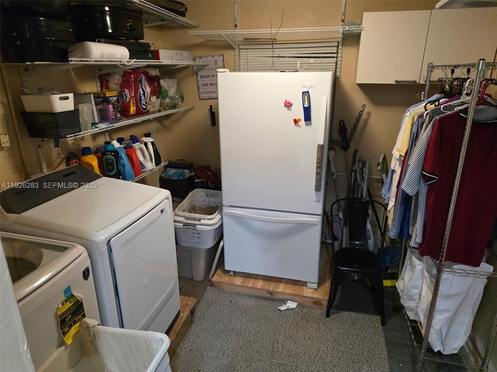 7331 Normandy Street Miramar, FL 33023 - Photo 13 of 29 a view of walk in closet with clothes and shoes