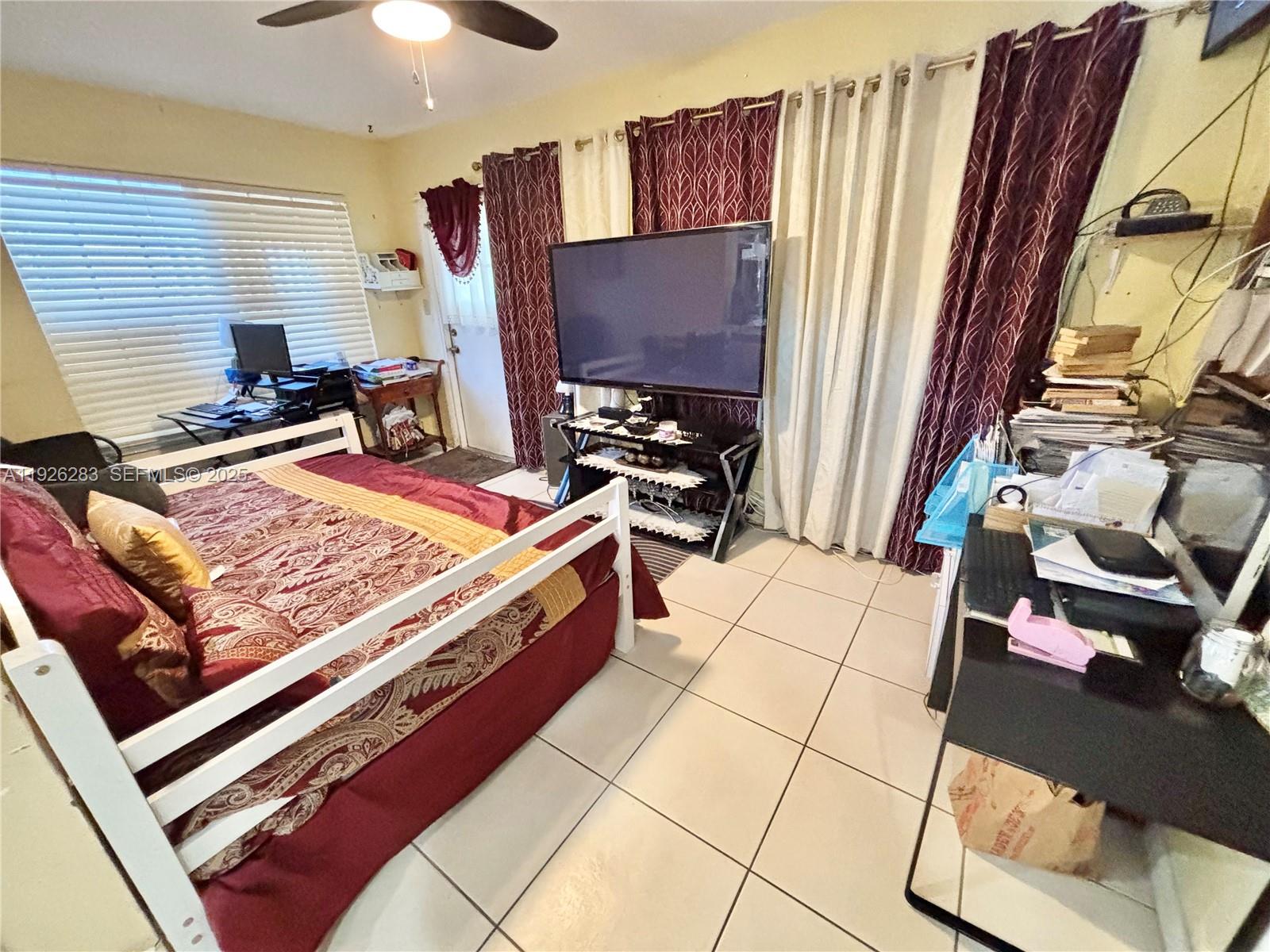7331 Normandy Street Miramar, FL 33023 - Photo 15 of 29 a bed sitting in a bedroom next to a window