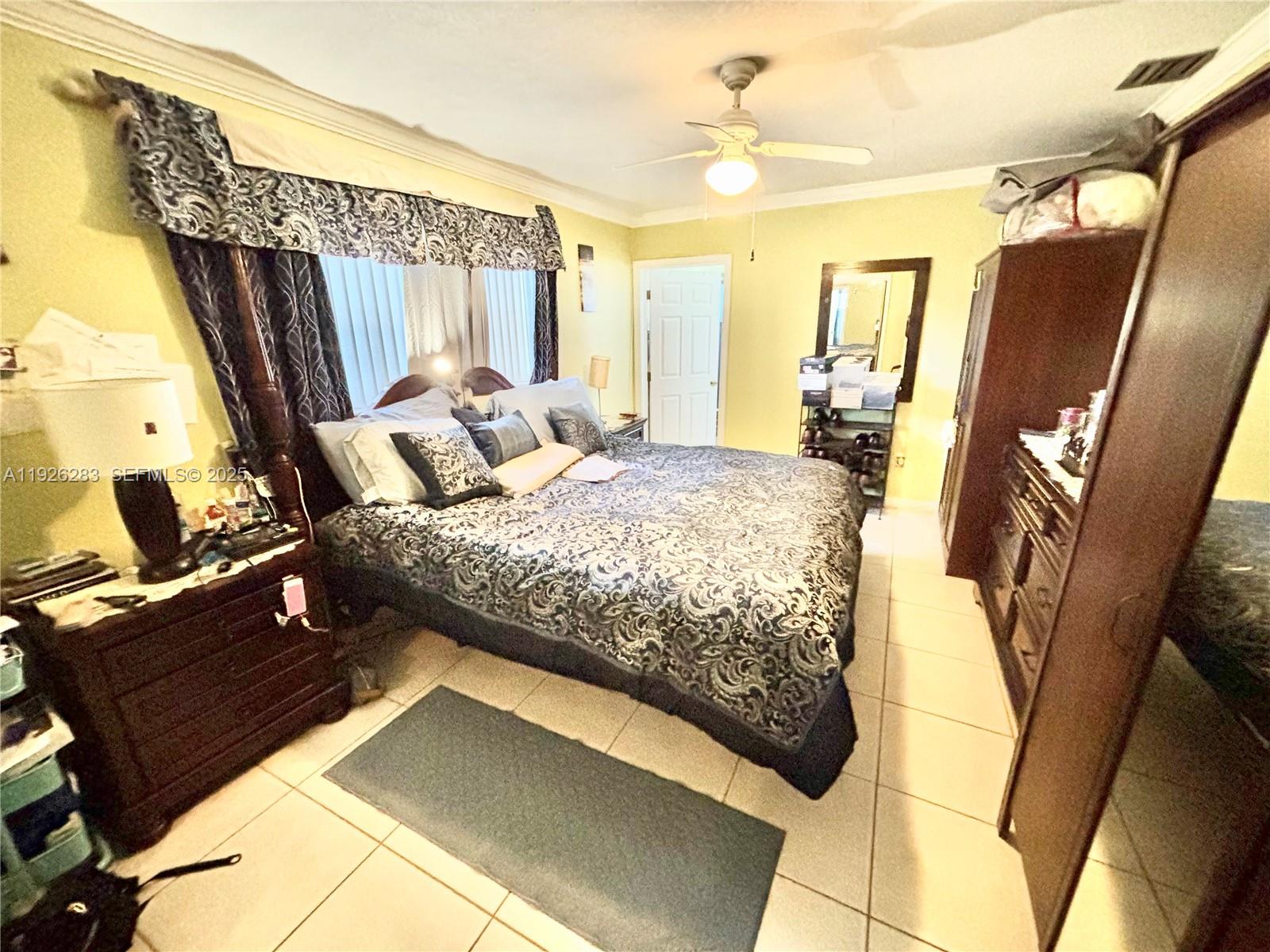7331 Normandy Street Miramar, FL 33023 - Photo 21 of 29 a bedroom with a bed next to a window