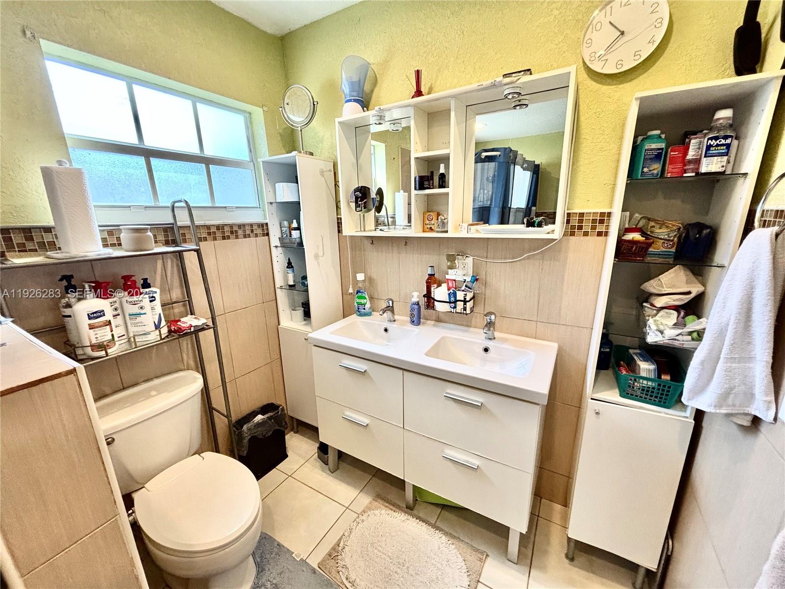 7331 Normandy Street Miramar, FL 33023 - Photo 24 of 29 a bathroom with a sink toilet vanity and a large mirror
