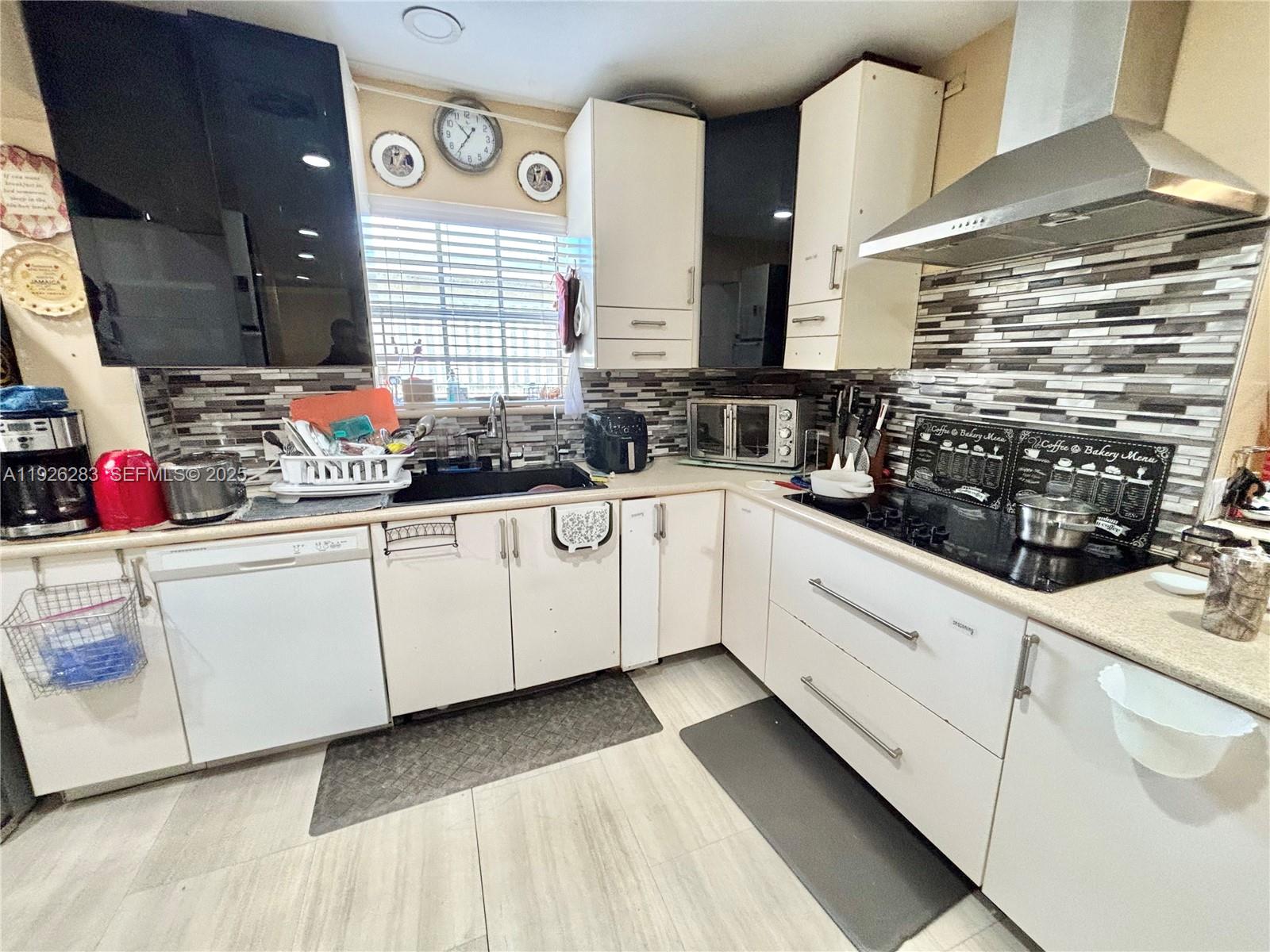 7331 Normandy Street Miramar, FL 33023 - Photo 10 of 29 a kitchen with white cabinets and sink