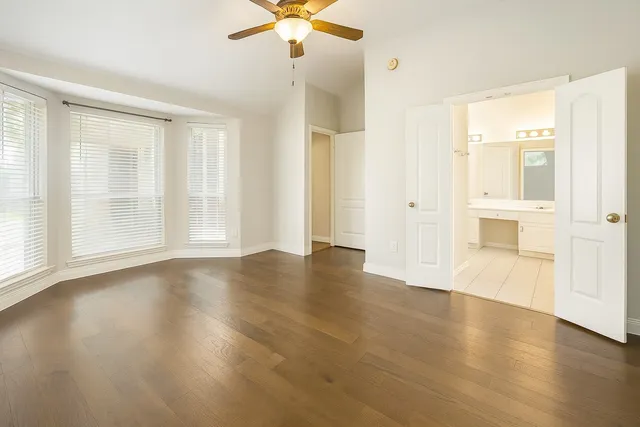 wooden floor in an empty room with a window