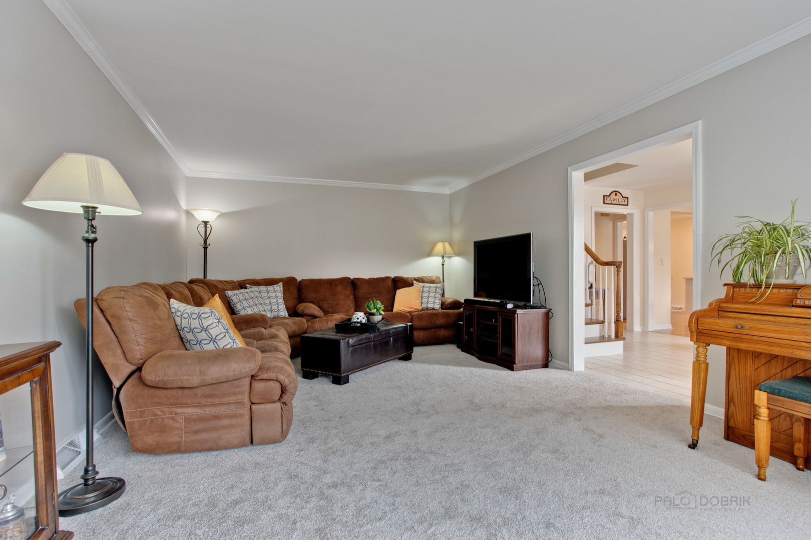 820 Freeman Road Hoffman Estates, IL 60192 - Photo 11 of 33 a living room with furniture and a flat screen tv