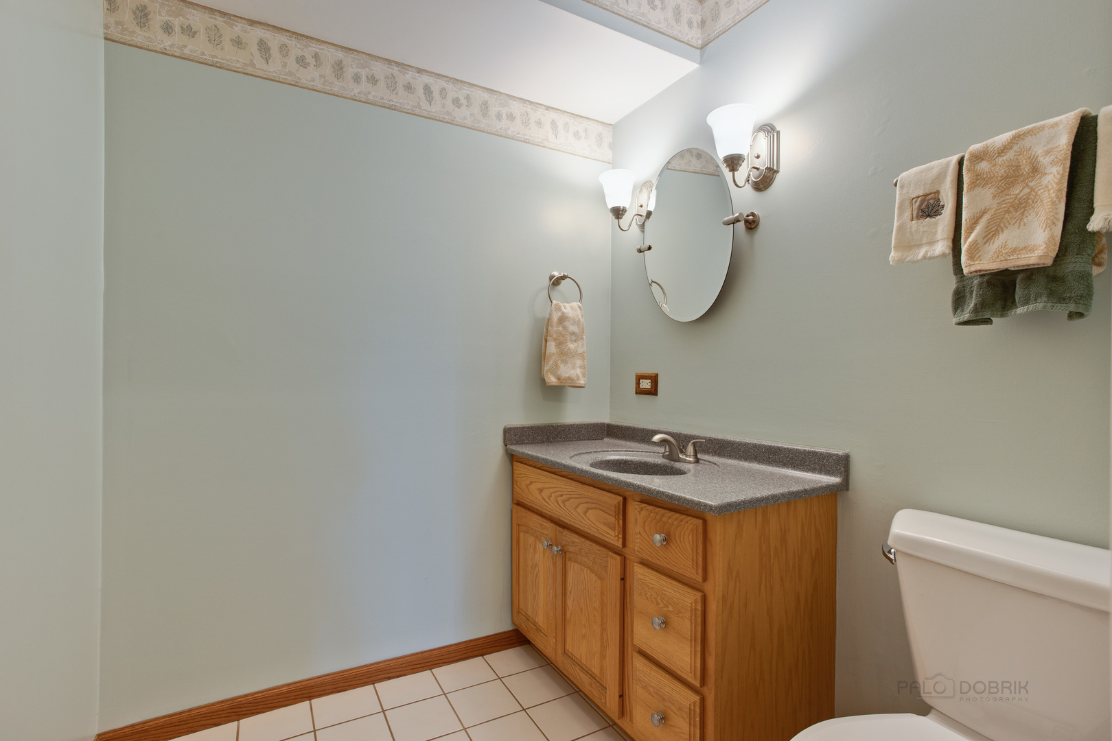 820 Freeman Road Hoffman Estates, IL 60192 - Photo 15 of 33 a bathroom with a granite countertop sink a toilet and a mirror