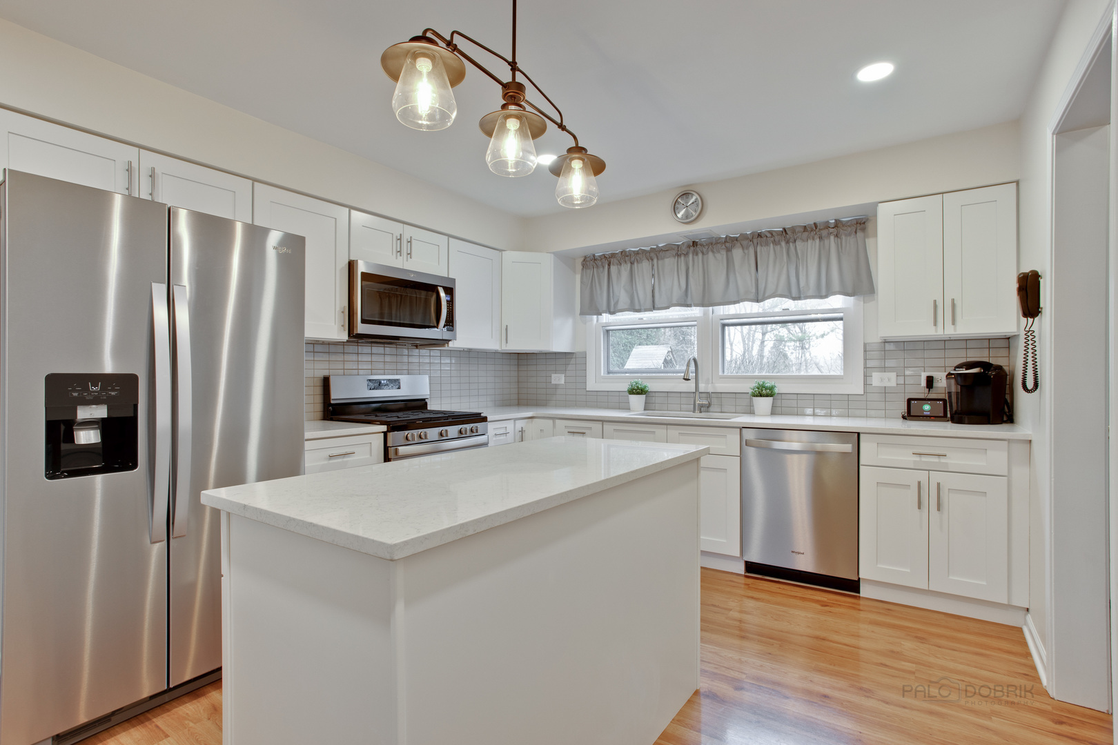 820 Freeman Road Hoffman Estates, IL 60192 - Photo 5 of 33 a kitchen with refrigerator cabinets and wooden floor