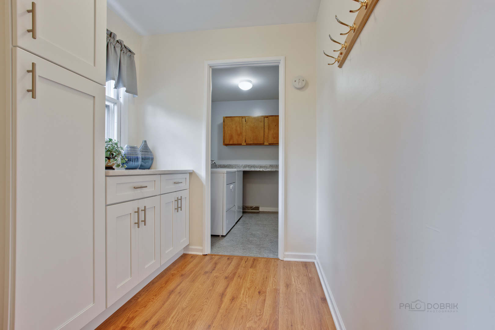 820 Freeman Road Hoffman Estates, IL 60192 - Photo 9 of 33 a view of a hallway to a room with wooden floor and cabinet
