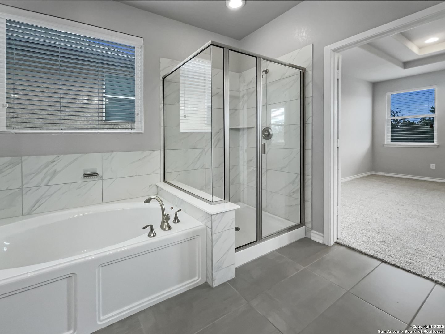 23006 Woodlawn Ridge San Antonio, TX 78259 - Photo 11 of 20 a bathroom with a bathtub and a shower