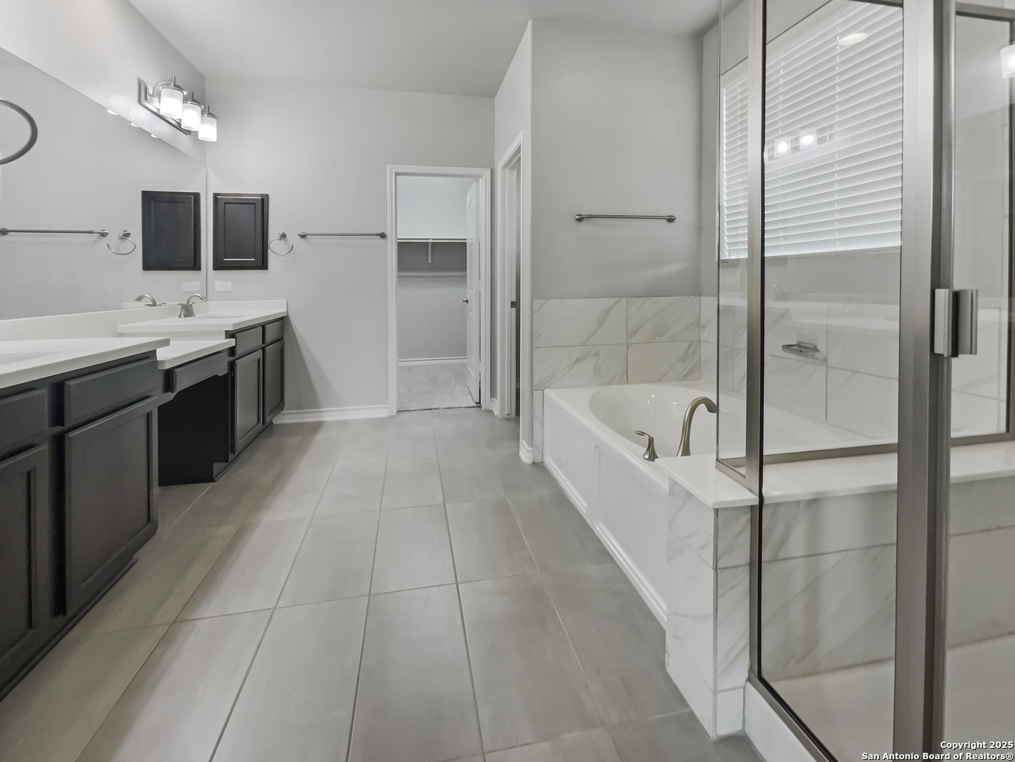 23006 Woodlawn Ridge San Antonio, TX 78259 - Photo 15 of 20 a large white bathroom with a tub a double vanity sink a mirror and a shower