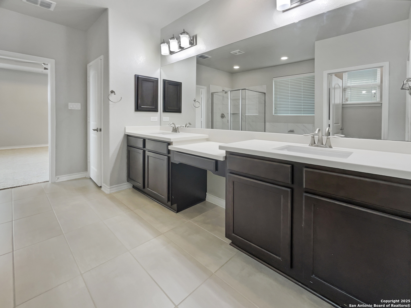 23006 Woodlawn Ridge San Antonio, TX 78259 - Photo 16 of 20 a kitchen with a sink and white cabinets