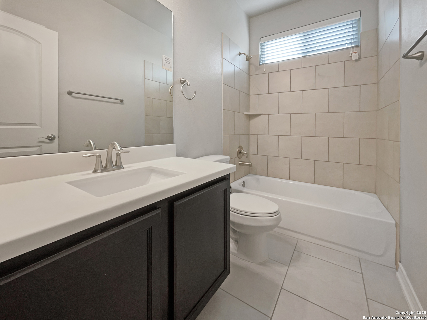 23006 Woodlawn Ridge San Antonio, TX 78259 - Photo 7 of 20 a bathroom with a sink a toilet and bathtub