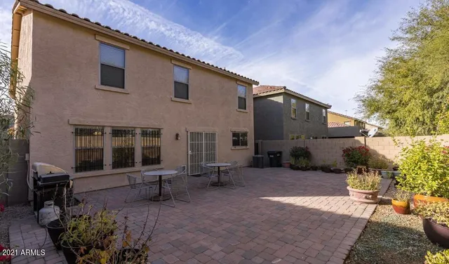 a view of a house with backyard and sitting area