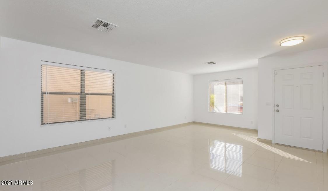 9446 Virginia Avenue Phoenix, AZ 85037 - Photo 4 of 19 a view of an empty room with a window