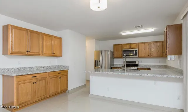 a kitchen with a sink a stove and cabinets