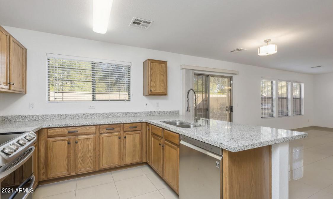 9446 Virginia Avenue Phoenix, AZ 85037 - Photo 7 of 19 a kitchen with a sink and cabinets