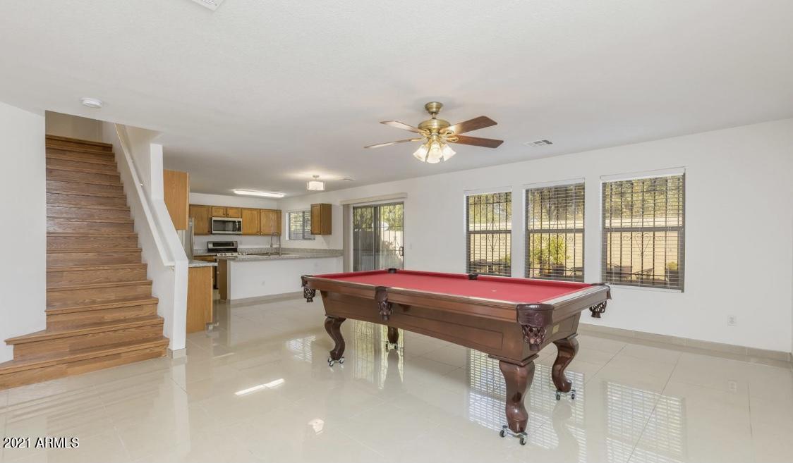 9446 Virginia Avenue Phoenix, AZ 85037 - Photo 9 of 19 a room with pool table and windows