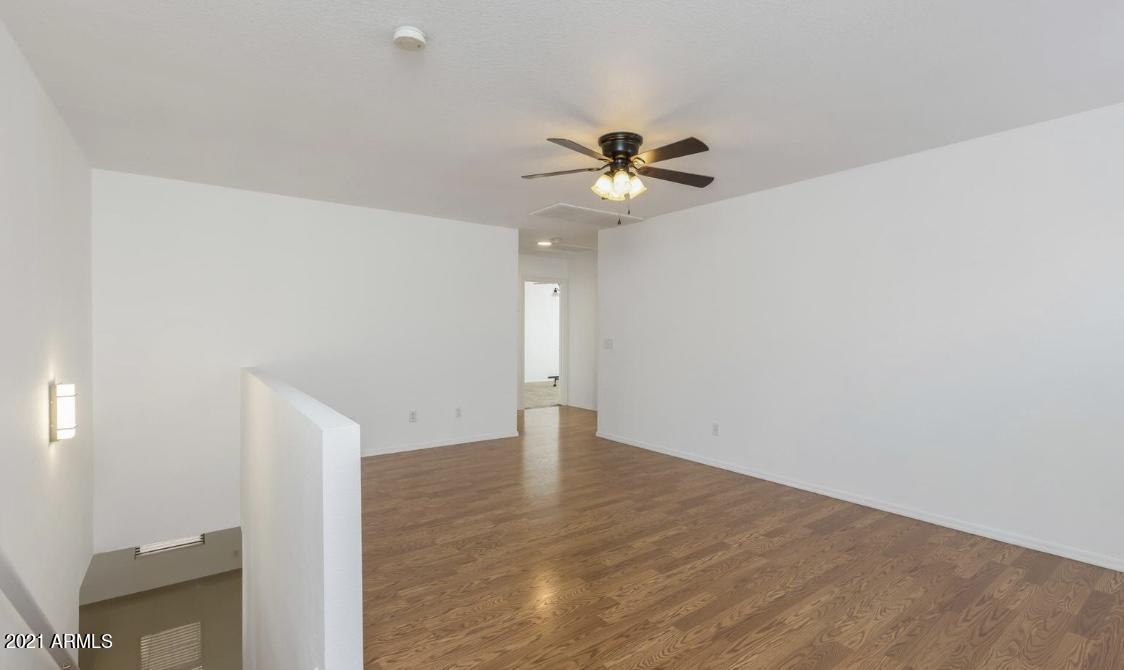 9446 Virginia Avenue Phoenix, AZ 85037 - Photo 10 of 19 a view of an empty room with a window