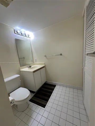 a white toilet sitting next to a bathroom sink