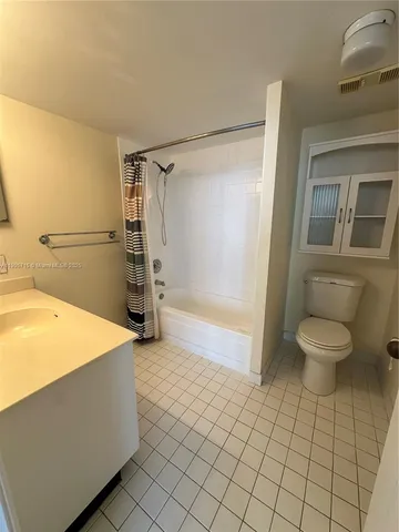 a bathroom with a sink a toilet and a shower