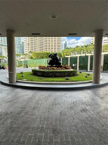 a view of a room with a large windows and plants