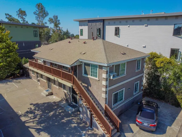 an aerial view of residential houses with yard
