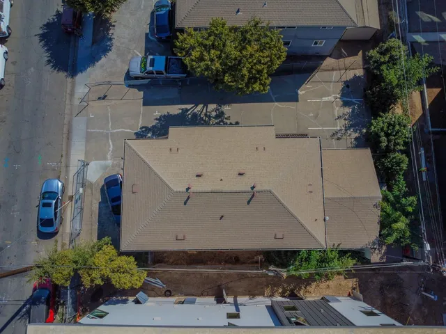 an aerial view of a house with a yard