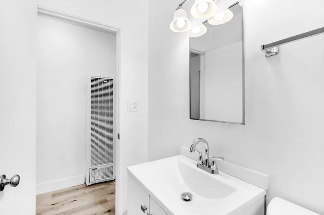 a bathroom with a sink a mirror and a shower