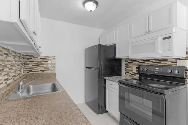 a kitchen with a stove and a refrigerator