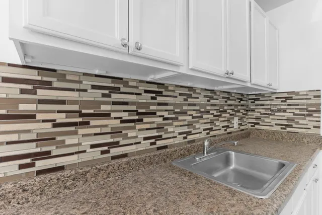 a kitchen with stainless steel appliances granite countertop a sink a stove and a granite counter tops