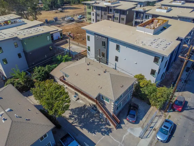 an aerial view of a house with a yard and potted plants