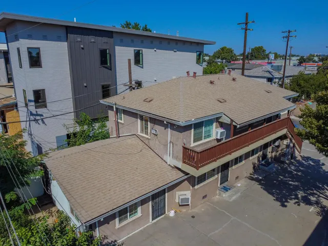 a aerial view of a house with a yard and potted plants